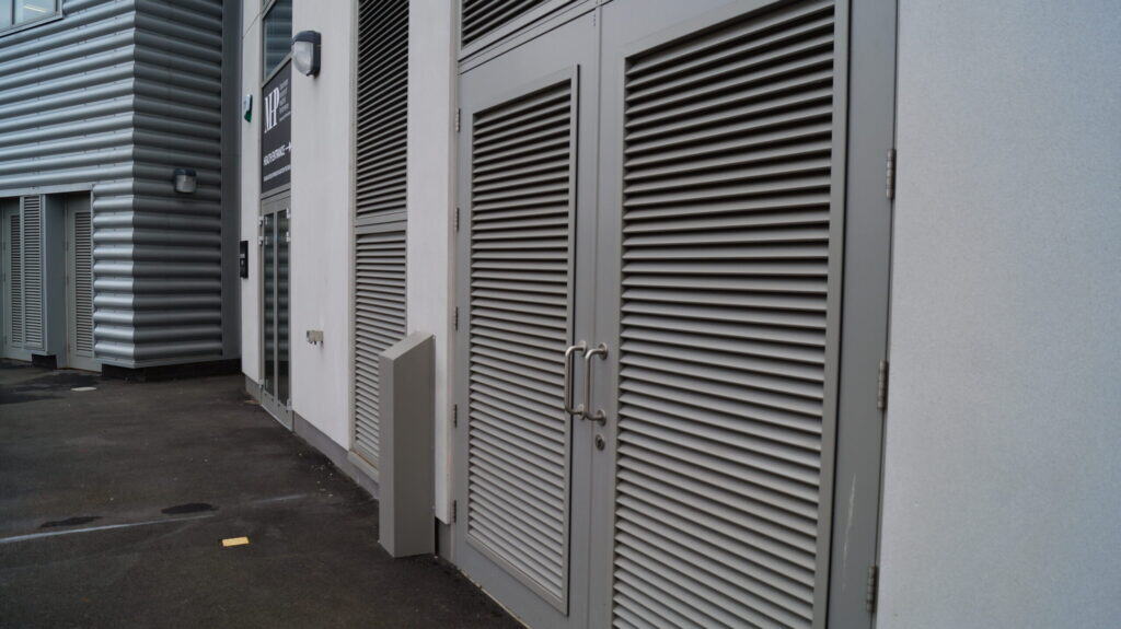 Modern industrial building with metal louvred doors