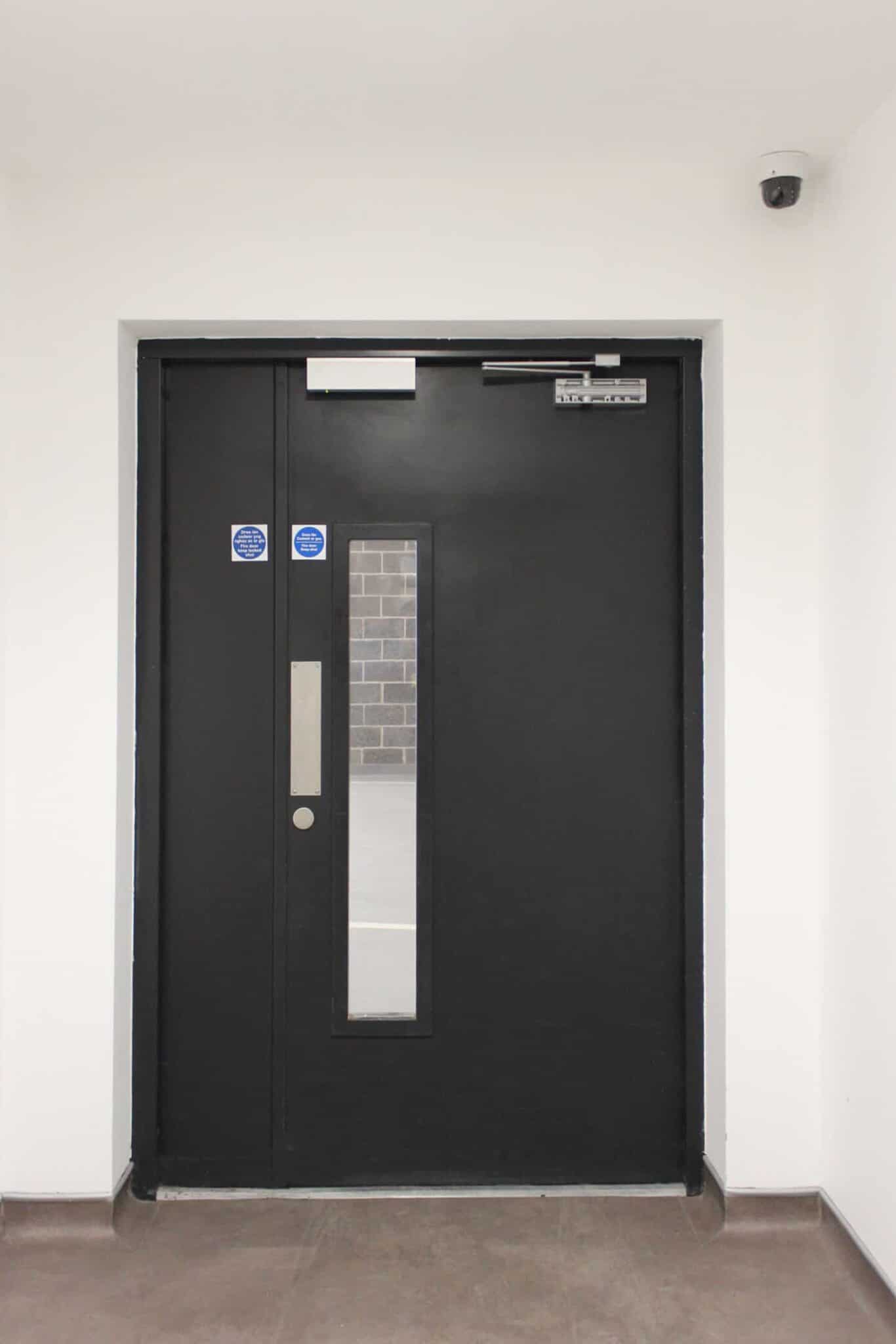 Black fire door with safety glass panel