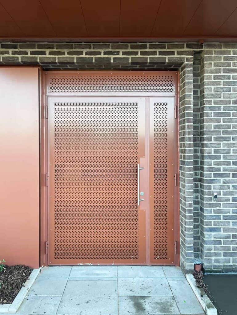 Metal perforated door with geometric triangle pattern