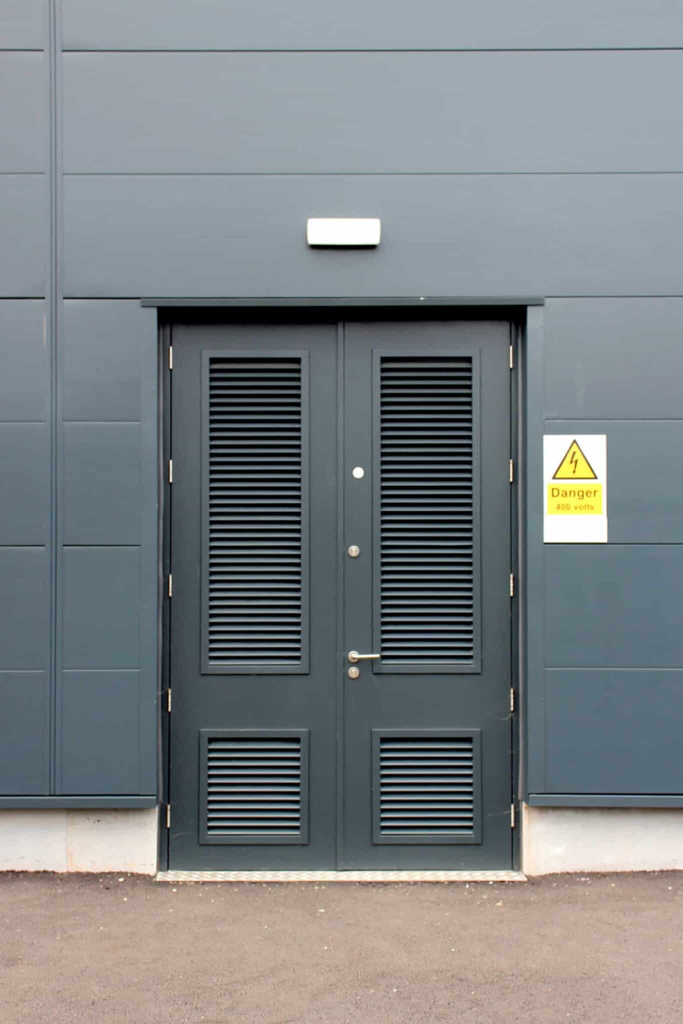 Industrial grey door with danger high voltage sign