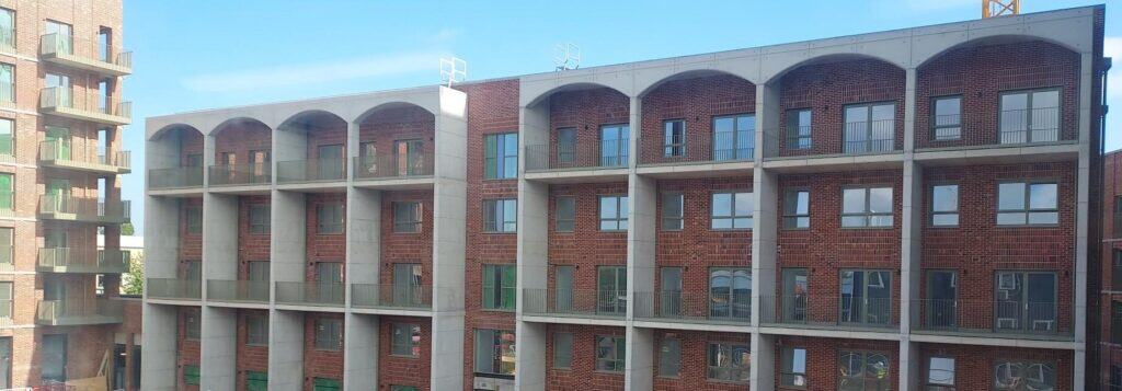 Modern red brick apartment building with balconies