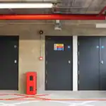 Industrial fire doors with warning signs in car park