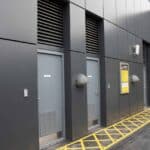 Industrial building doors with warning signs and ventilation panels