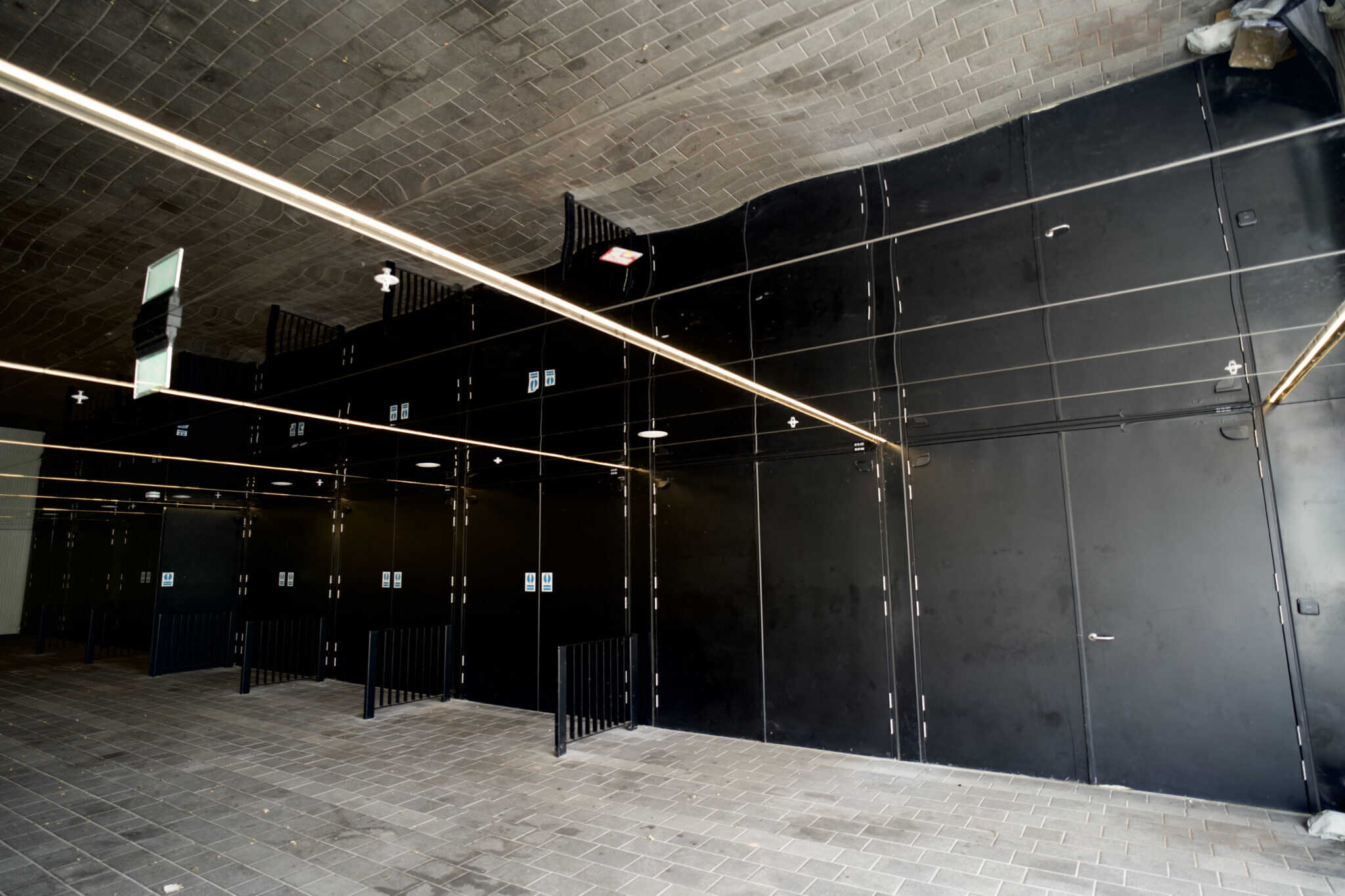Modern black industrial interior with brick ceiling